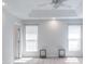 Spacious bedroom featuring tray ceiling, ceiling fan, and ample natural light from two windows at 12036 Duke Lancaster Dr, Charlotte, NC 28277