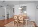 Open dining area with hardwood floors, wooden table and four chairs, and stairway at 12036 Duke Lancaster Dr, Charlotte, NC 28277