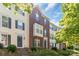 Charming townhome featuring a brick facade, bay window, and well-maintained landscaping at 12036 Duke Lancaster Dr, Charlotte, NC 28277