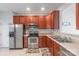 Cherry wood kitchen with stainless steel appliances and pass through view to dining room at 12036 Duke Lancaster Dr, Charlotte, NC 28277