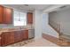 Open kitchen area with stainless steel appliances, wooden cabinets, and easy access to the stairs at 12036 Duke Lancaster Dr, Charlotte, NC 28277