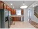 Spacious kitchen with wooden cabinets, stainless steel appliances, and open view to stairway and living area at 12036 Duke Lancaster Dr, Charlotte, NC 28277