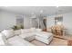 Open-concept living room featuring a large sectional, access to the staircase and dining area at 12036 Duke Lancaster Dr, Charlotte, NC 28277
