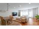 Bright living room features a dining area and a plush sectional couch by a large window at 12036 Duke Lancaster Dr, Charlotte, NC 28277