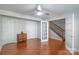 A spacious living room featuring hardwood floors, a ceiling fan, and easy access to the staircase at 12036 Duke Lancaster Dr, Charlotte, NC 28277