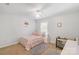 Bright bedroom featuring a ceiling fan, window, and a bed with pink and orange patterned linens at 1219 Century Dr, Clover, SC 29710