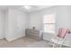 Bright bedroom featuring neutral carpet, a large dresser, a rocking chair, and a window at 1219 Century Dr, Clover, SC 29710