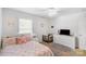 Bedroom featuring a TV, dresser, a window and a bed with pink and orange patterned linens at 1219 Century Dr, Clover, SC 29710