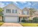Inviting two-story home featuring a well-kept lawn and an attached two-car garage at 1219 Century Dr, Clover, SC 29710