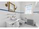 Bright bathroom with white tiled walls, bowl sink, and stylish gold fixtures at 1233 General Hoke Dr, Lincolnton, NC 28092