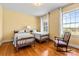Cozy bedroom featuring two twin beds, hardwood floors, and natural light from the windows at 1233 General Hoke Dr, Lincolnton, NC 28092
