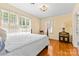 Cozy bedroom featuring hardwood floors, neutral walls, and sunlit windows with blinds at 1233 General Hoke Dr, Lincolnton, NC 28092