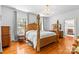 A spacious bedroom featuring a carved wooden four-poster bed and hardwood floors at 1233 General Hoke Dr, Lincolnton, NC 28092
