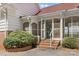 Welcoming entrance porch with brick steps, screened walls, and a white railing at 1233 General Hoke Dr, Lincolnton, NC 28092
