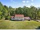 Expansive home featuring a classic facade with white columns, a red roof, and a sprawling green lawn at 1233 General Hoke Dr, Lincolnton, NC 28092