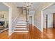 Elegant foyer featuring a chandelier, hardwood floors, a staircase, and ornate wallpaper at 1233 General Hoke Dr, Lincolnton, NC 28092