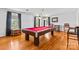 Entertaining game room showcasing a red billiard table, hardwood floors, and natural light at 1233 General Hoke Dr, Lincolnton, NC 28092