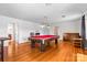 Spacious game room with billiard table, hardwood floors, and access to multiple rooms at 1233 General Hoke Dr, Lincolnton, NC 28092