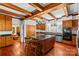 Bright kitchen with center island, stainless appliances, and wood floors, blending rustic charm with modern convenience at 1233 General Hoke Dr, Lincolnton, NC 28092