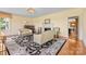 A bright living room boasts hardwood floors, a fireplace, a patterned rug, and lots of natural light at 1233 General Hoke Dr, Lincolnton, NC 28092
