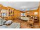 Spacious living room featuring wood paneling, a fireplace, built-in bookcases, and ample seating at 1233 General Hoke Dr, Lincolnton, NC 28092