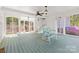 Large screened porch with white trim, green painted floors, and outdoor furniture at 1233 General Hoke Dr, Lincolnton, NC 28092