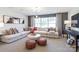 Comfortable living room featuring a large sectional sofa, stylish ottomans, and a modern chandelier at 124 Fordham Ct # 19, Fort Mill, SC 29715
