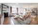 Open-concept living space with hardwood floors, modern decor, a cozy fireplace, and dining area at 124 Fordham Ct # 19, Fort Mill, SC 29715