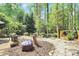 Landscaped backyard with seating and mature trees at 1432 Deer Forest Dr, Fort Mill, SC 29707