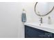 Bathroom with a vessel sink, navy blue vanity, round mirror, and nautical decor at 1432 Deer Forest Dr, Fort Mill, SC 29707