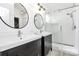 Modern bathroom featuring double sink vanity, round mirrors, and a glass-enclosed shower at 1432 Deer Forest Dr, Fort Mill, SC 29707
