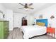 Bright bedroom with blue headboard, white linens, ceiling fan, and unique colorful furnishings at 1432 Deer Forest Dr, Fort Mill, SC 29707