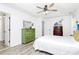 Bright bedroom featuring a ceiling fan, white bedding, wood floors and ensuite bathroom at 1432 Deer Forest Dr, Fort Mill, SC 29707