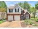 Charming two-story home with a brick and siding exterior, complemented by a well-manicured front yard at 1432 Deer Forest Dr, Fort Mill, SC 29707