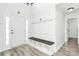 Bright foyer featuring gray floors, white walls, a bench with storage, and a coat rack at 1432 Deer Forest Dr, Fort Mill, SC 29707