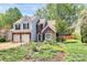 Charming two-story home with a well-manicured lawn, flower beds, and an attached two-car garage at 1432 Deer Forest Dr, Fort Mill, SC 29707