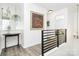 Upstairs hallway featuring wooden floors, modern railing and wall art, creating an open, airy and bright space at 1432 Deer Forest Dr, Fort Mill, SC 29707