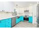 Modern kitchen with white cabinets, subway tile backsplash, stainless steel appliances, and turquoise lower cabinets at 1432 Deer Forest Dr, Fort Mill, SC 29707