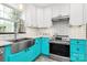 Bright kitchen featuring white cabinetry, stainless steel appliances, farmhouse sink, subway tile backsplash and turquoise cabinets at 1432 Deer Forest Dr, Fort Mill, SC 29707