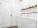 Bright laundry room with white washer and dryer and white cabinets at 1432 Deer Forest Dr, Fort Mill, SC 29707