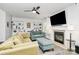 Bright living room featuring comfortable seating, a fireplace, built-in bookshelves, and a ceiling fan at 1432 Deer Forest Dr, Fort Mill, SC 29707