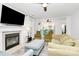 Bright living room featuring a fireplace, comfortable seating, and a view of the kitchen, creating an inviting space at 1432 Deer Forest Dr, Fort Mill, SC 29707