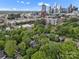 Stunning aerial view showcasing a home nestled among lush greenery, with the city skyline in the background at 1514 S Rensselaer Pl, Charlotte, NC 28203