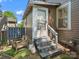 Back entrance with wooden door and steps with a small seating area and artificial turf grass at 1514 S Rensselaer Pl, Charlotte, NC 28203