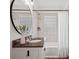 Stylish bathroom with a granite countertop vanity, decorative mirror, and tiled shower at 1514 S Rensselaer Pl, Charlotte, NC 28203
