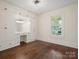 Bright bedroom features hardwood floors, built in cabinets and desk and a window with natural light at 1514 S Rensselaer Pl, Charlotte, NC 28203