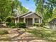 Beautiful single-Gathering home with a brick pathway, lush landscaping, and a covered porch at 1514 S Rensselaer Pl, Charlotte, NC 28203