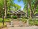 Charming home exterior featuring a brick driveway, mature trees, and a cozy front porch at 1514 S Rensselaer Pl, Charlotte, NC 28203