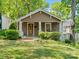 Charming home featuring a well-manicured lawn, a brick pathway, and a welcoming covered porch at 1514 S Rensselaer Pl, Charlotte, NC 28203