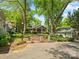 Quaint home surrounded by lush greenery, featuring a welcoming front porch and brick pathway at 1514 S Rensselaer Pl, Charlotte, NC 28203